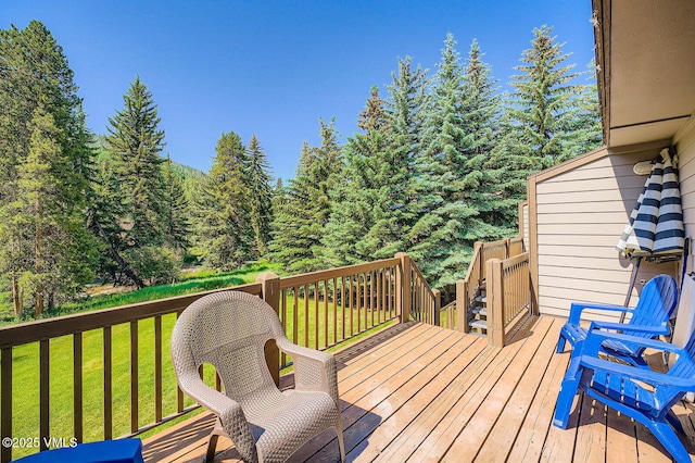 1750 S Frontage Rd W Unit E-3, Vail, CO 81657 - wooden deck featuring a lawn and a wooded view