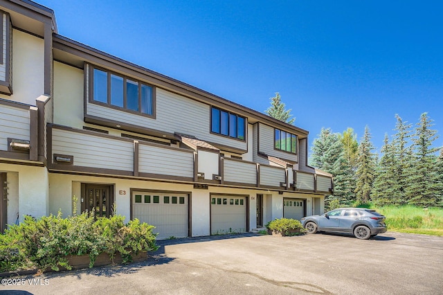 1750 S Frontage Rd W Unit E-3, Vail, CO 81657 - view of front of home featuring stucco siding, driveway, an attached garage, and a balcony