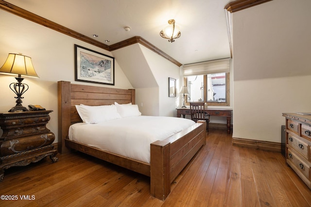 bedroom featuring ornamental molding and hardwood / wood-style floors