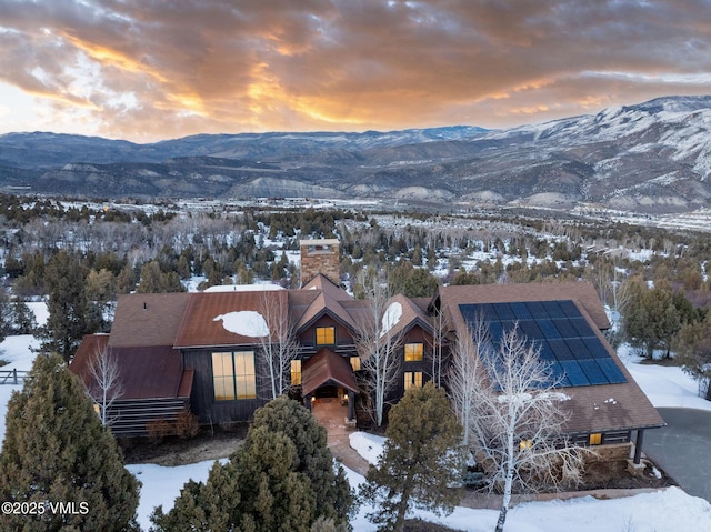 snowy aerial view with a mountain view