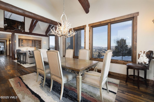 dining space featuring a notable chandelier, vaulted ceiling with beams, dark wood-style floors, and baseboards