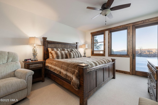 bedroom featuring access to exterior, light carpet, baseboards, and a ceiling fan