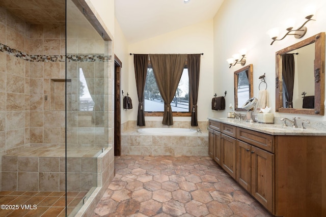 bathroom featuring vaulted ceiling, a garden tub, tiled shower, and a sink