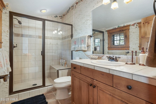 124 Grey Hawk Ln, Edwards, CO 81632 - bathroom featuring wallpapered walls, a stall shower, tile patterned flooring, toilet, and vanity