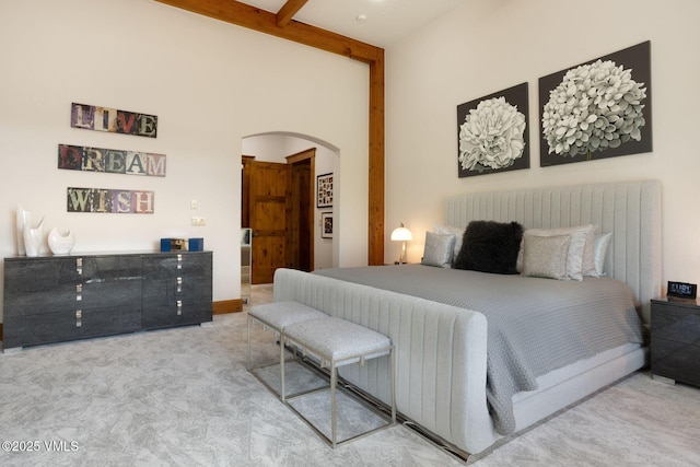 124 Grey Hawk Ln, Edwards, CO 81632 - bedroom with arched walkways, beam ceiling, and carpet floors