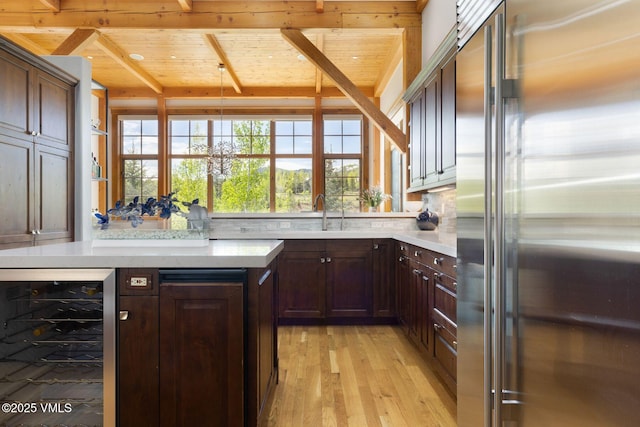 124 Grey Hawk Ln, Edwards, CO 81632 - kitchen featuring high end fridge, wine cooler, wooden ceiling with exposed beams, light countertops, and a sink