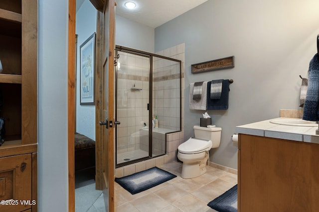124 Grey Hawk Ln, Edwards, CO 81632 - bathroom featuring a stall shower, toilet, vanity, and tile patterned floors