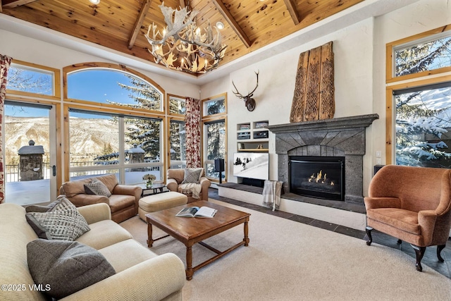 living room with a mountain view, wood ceiling, beamed ceiling, and a towering ceiling