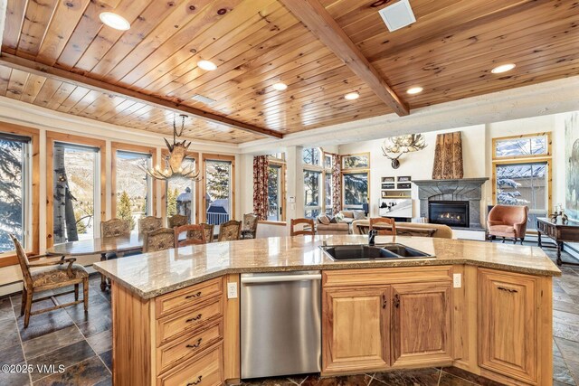 kitchen with a kitchen island with sink, sink, a wealth of natural light, and dishwasher