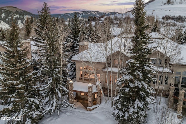 snowy aerial view featuring a mountain view