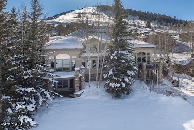 view of snow covered exterior featuring a mountain view