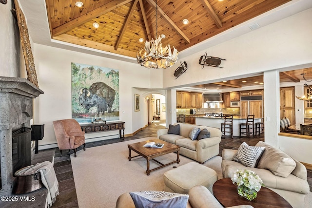 living room with beamed ceiling, a notable chandelier, and wood ceiling