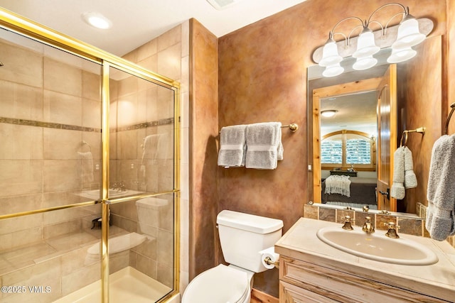 bathroom featuring an enclosed shower, vanity, and toilet