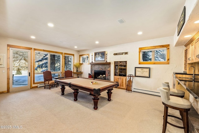 recreation room featuring a tile fireplace, sink, pool table, light colored carpet, and baseboard heating