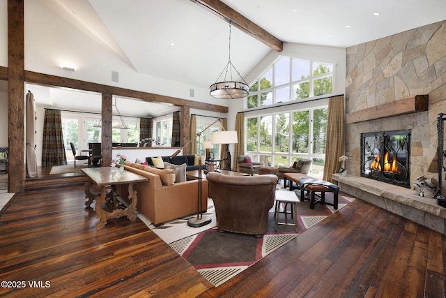 2005 Wildwood Rd, Avon, CO 81620 - living area featuring high vaulted ceiling, wood-type flooring, plenty of natural light, a fireplace, and beam ceiling