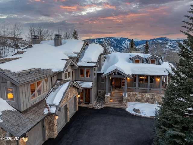 2005 Wildwood Rd, Avon, CO 81620 - rustic home featuring a chimney, a mountain view, driveway, and board and batten siding
