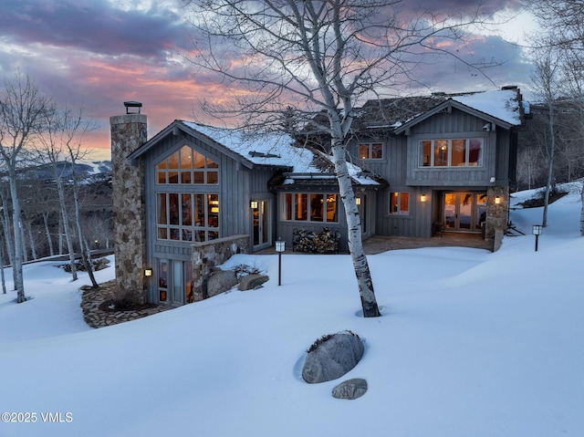 2005 Wildwood Rd, Avon, CO 81620 - snow covered back of property with a chimney and board and batten siding