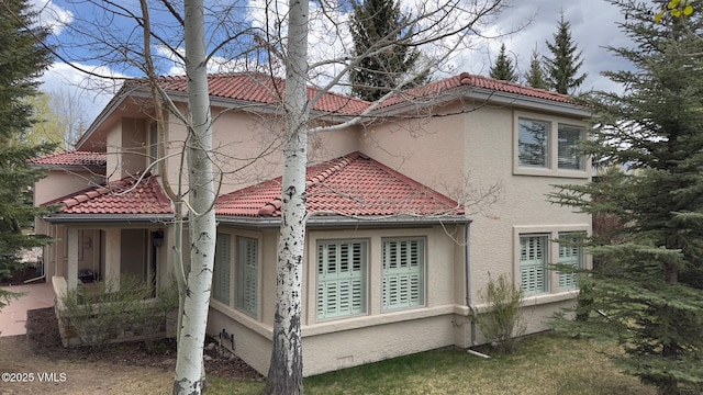 130 Morgan Dr Unit B, Edwards, CO 81632 - view of side of home with a tiled roof and stucco siding