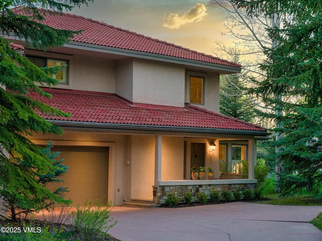 130 Morgan Dr Unit B, Edwards, CO 81632 - mediterranean / spanish-style house featuring covered porch, stucco siding, a tiled roof, and driveway