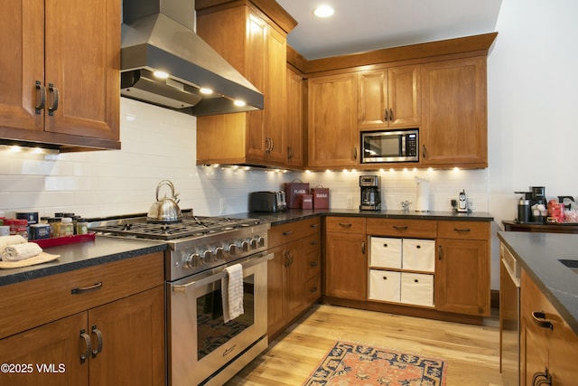 kitchen with stainless steel appliances, tasteful backsplash, ventilation hood, light hardwood / wood-style floors, and beverage cooler