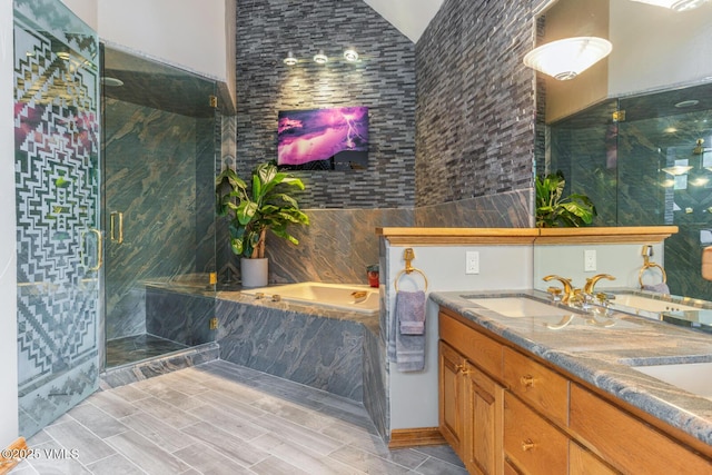 60 Elk Track Ct, Beaver Creek, CO 81620 - bathroom featuring a garden tub, a stall shower, double vanity, vaulted ceiling, and wood tiled floors