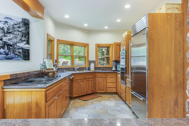 60 Elk Track Ct, Beaver Creek, CO 81620 - kitchen featuring recessed lighting, appliances with stainless steel finishes, light stone finish flooring, brown cabinets, and dark countertops