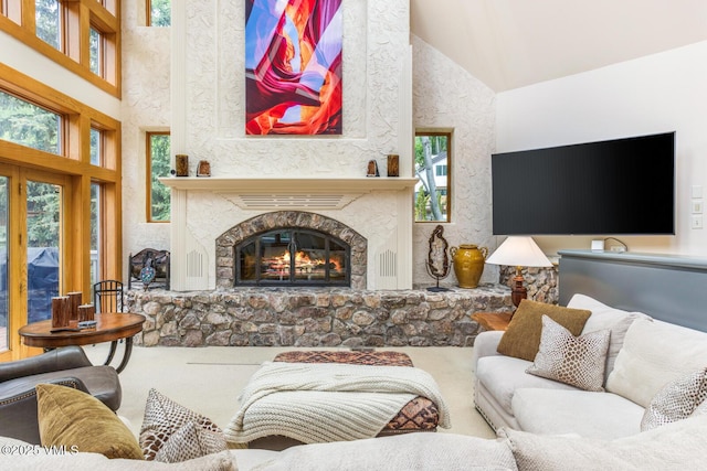 60 Elk Track Ct, Beaver Creek, CO 81620 - living area with carpet floors, a stone fireplace, plenty of natural light, and a towering ceiling