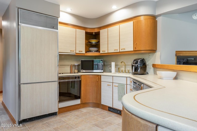 60 Elk Track Ct, Beaver Creek, CO 81620 - kitchen featuring paneled built in fridge, black oven, light countertops, open shelves, and recessed lighting