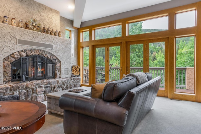 60 Elk Track Ct, Beaver Creek, CO 81620 - living room with carpet flooring, a stone fireplace, and a towering ceiling