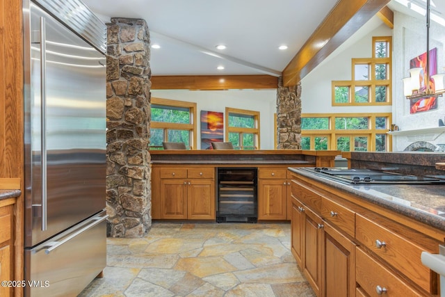 60 Elk Track Ct, Beaver Creek, CO 81620 - kitchen with stainless steel appliances, beverage cooler, light stone finish floors, brown cabinetry, and recessed lighting