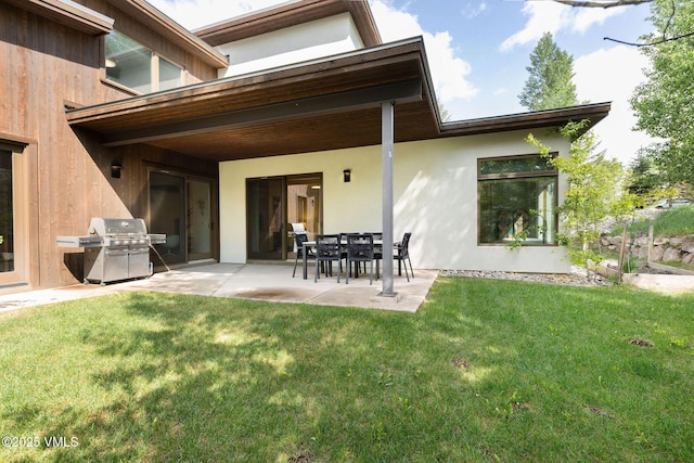 232 Stetson Dr, Edwards, CO 81632 - back of property with a patio, a yard, and stucco siding