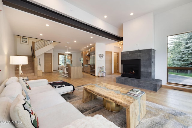 232 Stetson Dr, Edwards, CO 81632 - living room with stairway, recessed lighting, light wood finished floors, a tiled fireplace, and beam ceiling