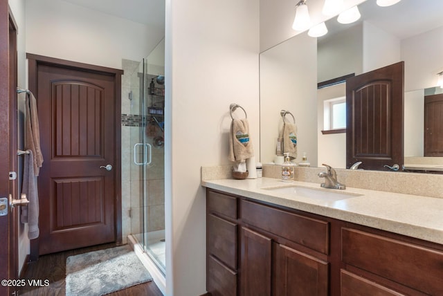 full bath with vanity and a stall shower