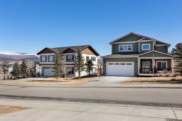 view of front of property with concrete driveway, a mountain view, an attached garage, and a porch