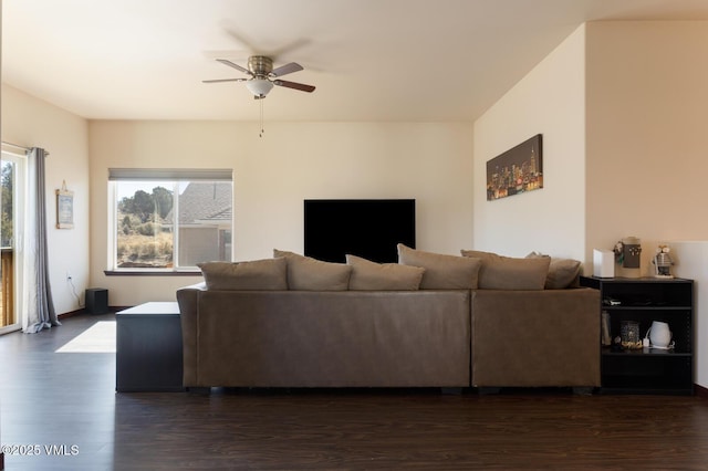 living area with dark wood-type flooring and ceiling fan