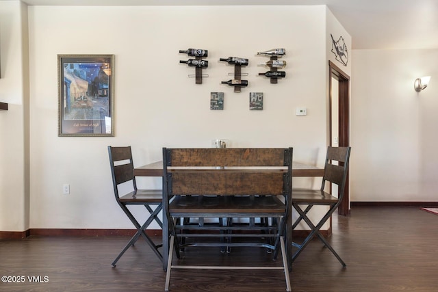 dining area featuring baseboards and dark wood-style flooring