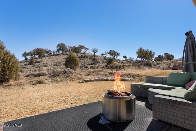 view of patio / terrace with an outdoor living space with a fire pit