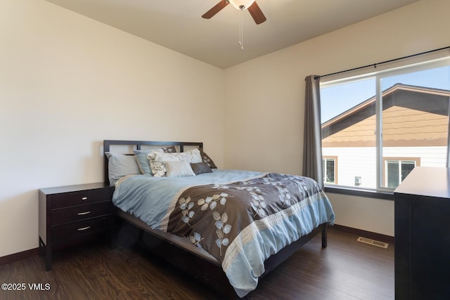 bedroom with visible vents, multiple windows, and wood finished floors