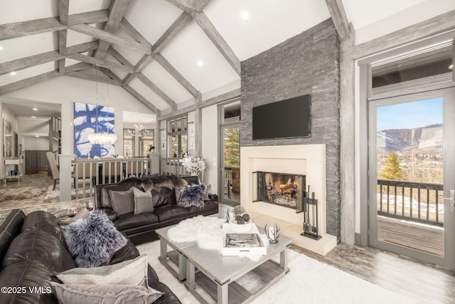 25 W Timber Draw Dr, Edwards, CO 81632 - living room with beamed ceiling, a glass covered fireplace, high vaulted ceiling, recessed lighting, and wood finished floors