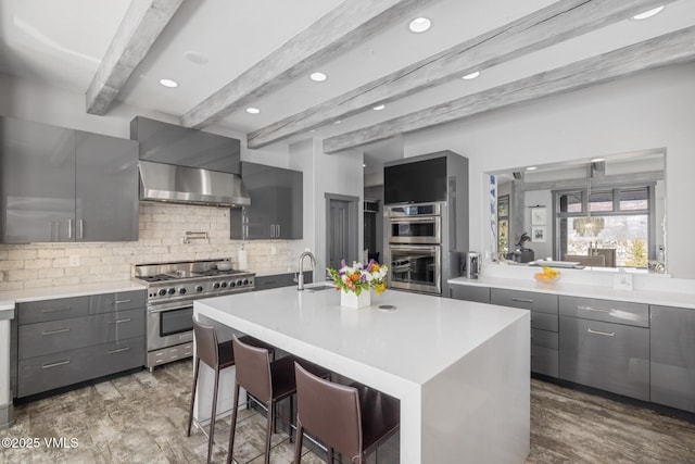 25 W Timber Draw Dr, Edwards, CO 81632 - kitchen featuring stainless steel appliances, wall chimney exhaust hood, gray cabinets, modern cabinets, and beam ceiling
