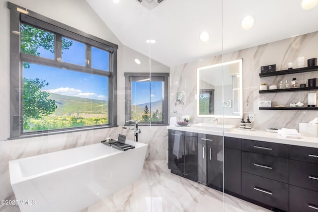 25 W Timber Draw Dr, Edwards, CO 81632 - bathroom featuring marble tiled floors, tile walls, vanity, lofted ceiling, and a soaking tub