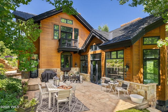 25 W Timber Draw Dr, Edwards, CO 81632 - rear view of property with a patio area and stone siding