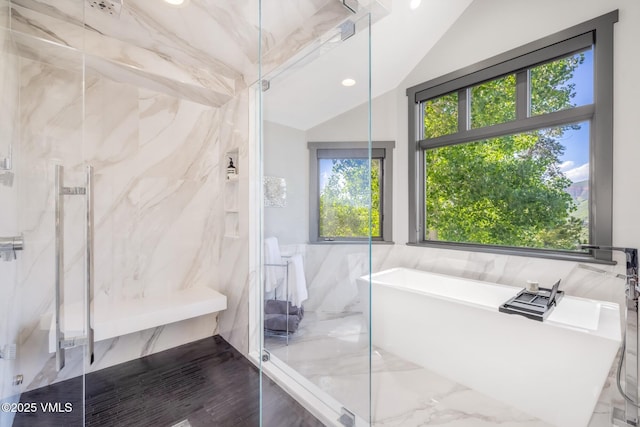 25 W Timber Draw Dr, Edwards, CO 81632 - full bathroom featuring tile walls, a marble finish shower, a freestanding tub, healthy amount of natural light, and lofted ceiling