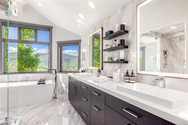25 W Timber Draw Dr, Edwards, CO 81632 - bathroom with double vanity, a soaking tub, marble tiled floors, vaulted ceiling, and recessed lighting
