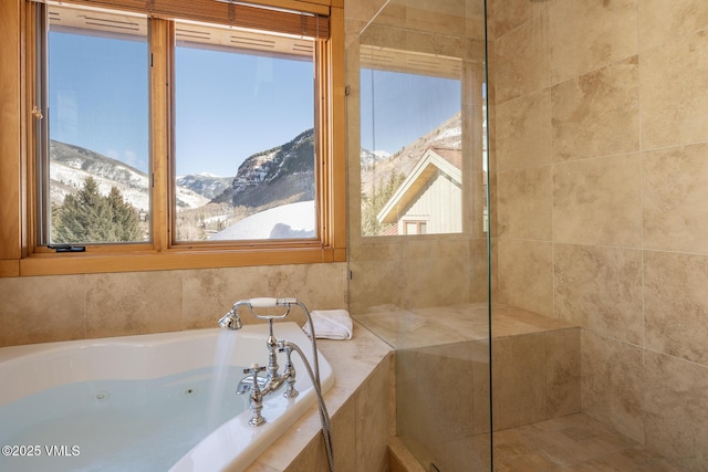 bathroom featuring a jetted tub and a mountain view