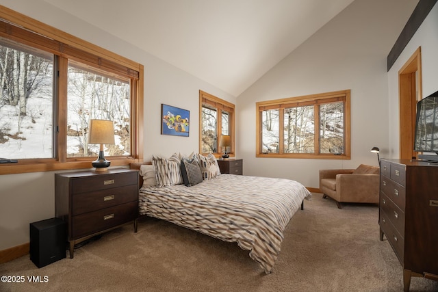 carpeted bedroom featuring high vaulted ceiling and multiple windows