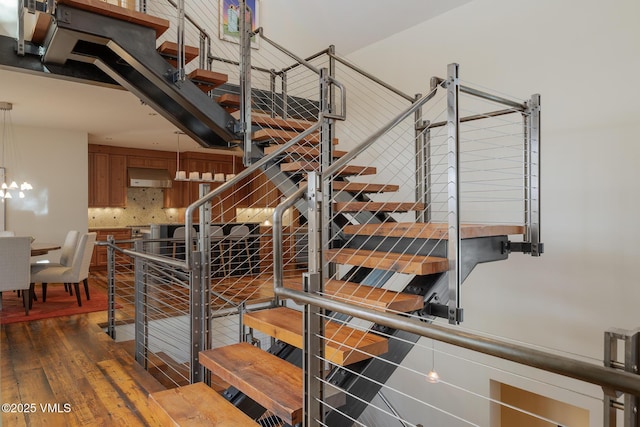 stairway featuring wood finished floors