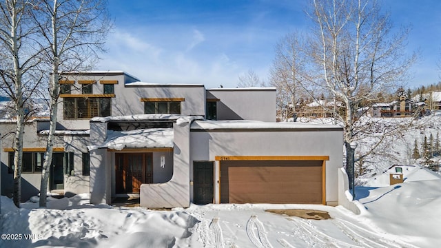 modern home featuring a garage and stucco siding