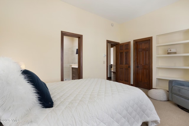 carpeted bedroom with ensuite bath