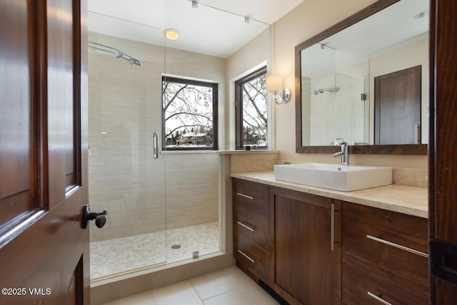 bathroom featuring a stall shower, vanity, and tile patterned floors